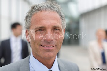 Close up portrait confident businessman with gray hair