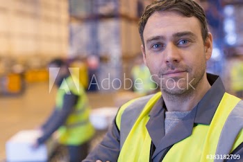 Close up portrait confident male worker in distribution warehouse