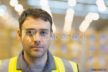 Close up portrait confident male worker in warehouse