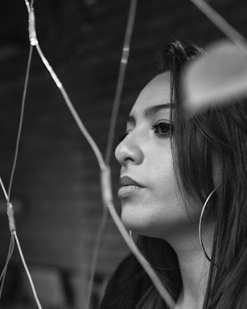 Close-up Portrait Grayscale Photo of Woman Behind Chain-link Fence Looking into the Distance