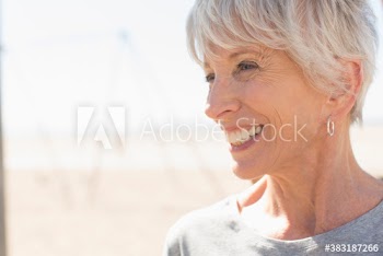 Close up portrait happy senior woman looking away