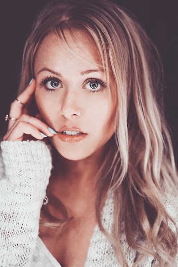 Close-up Portrait Photo of Woman Posing With Her Hand by Her Face
