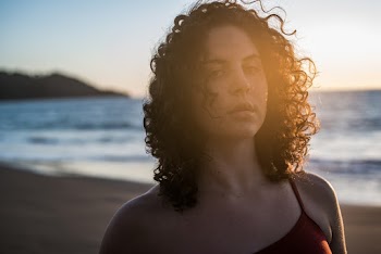 Close-up Portrait Photo of Woman Standing on the Beach