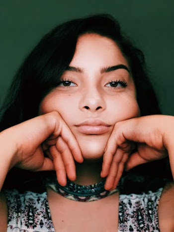 Close-up Portrait Photo of Woman With Her Head Resting On Her Knuckles
