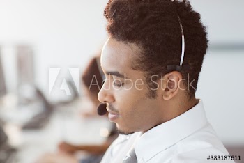 Close up profile young businessman with headset in call center