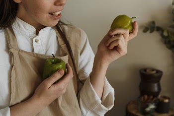 Close-Up Shot of a Person Holding Green Bell Peppers · Free Stock Photo