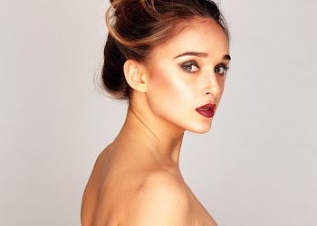 Close-up Side View Portrait Photo of Topless Woman Standing In Front White Background