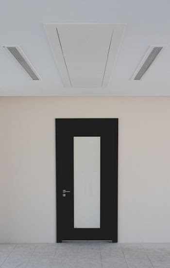 closed black and beige door on beige wall