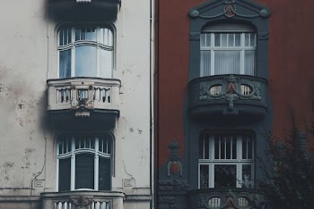 closed glass balcony doors of two buildings