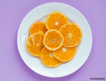 Closeup of a plate of sliced juicy orange