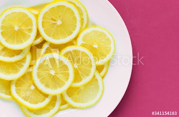 Closeup of a plate of sliced lemon textured background