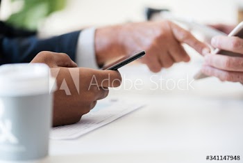 Closeup of businessmen using mobile phone