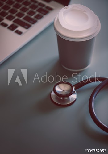 Closeup of doctor stethoscope with coffee paper cup