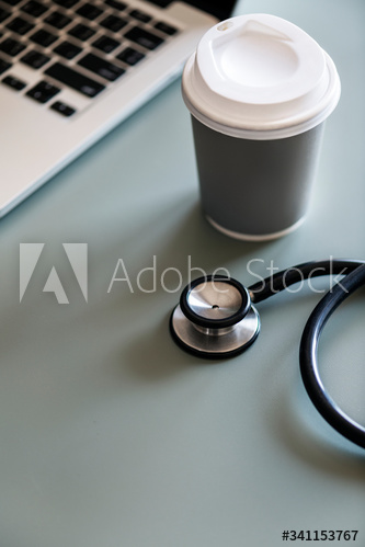 Closeup of doctor stethoscope with coffee paper cup