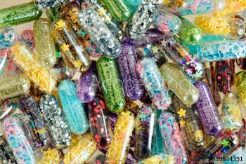 Closeup of glittery shimmery shiny pills capsule background