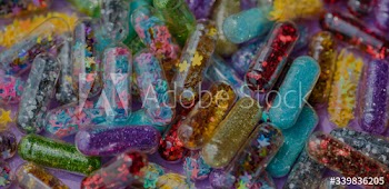 Closeup of glittery shimmery shiny pills capsule background
