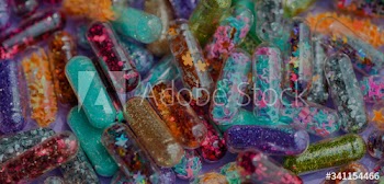 Closeup of glittery shimmery shiny pills capsule background