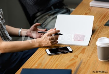 Closeup of secretary taking notes in a meeting
