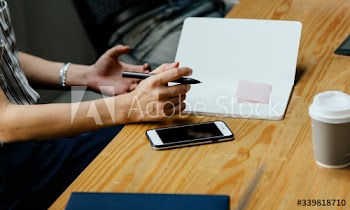 Closeup of secretary taking notes in a meeting