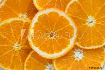 Closeup of sliced juicy oranges textured background