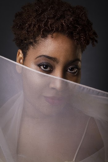 Closeup photo of a woman covering her face with a white sheer