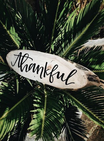 closeup photo of beige Thankful sign