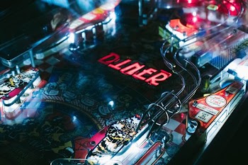 closeup photo of black and yellow pinball machine