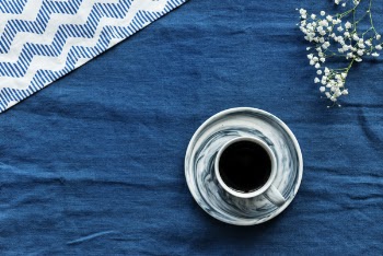 Closeup Photo of Gray and Black Teacup Filled by Coffee With Saucer