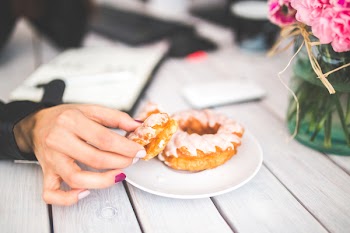 Closeup photo of hand choosing donut