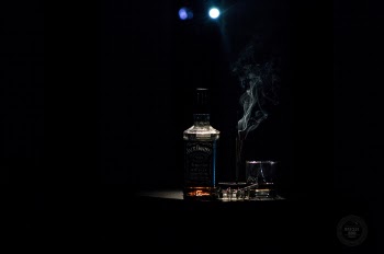 Closeup Photo of Liquor Bottle Against Black Background