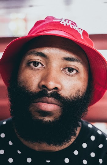 Closeup Photo of Man with Facial Hair and Red Hat