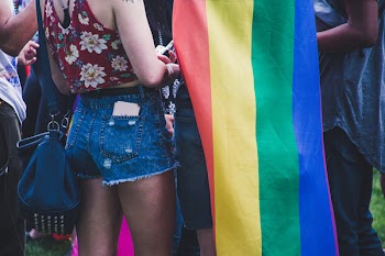 Closeup Photo of Person Wearing Blue Denim Short Shorts Near the Flag