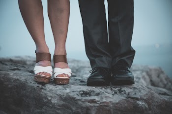 Closeup Photo of Two Person's Legs