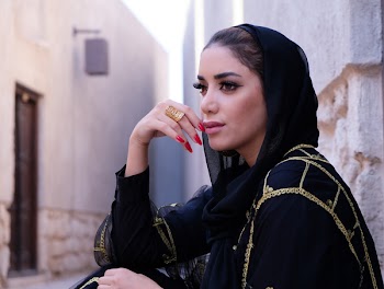 Closeup Photo of Woman Wearing Black Hijab Headdress Holding Her Lips
