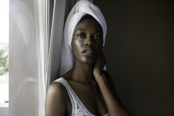 Closeup Photo of Woman Wearing White Top Looking on Camera