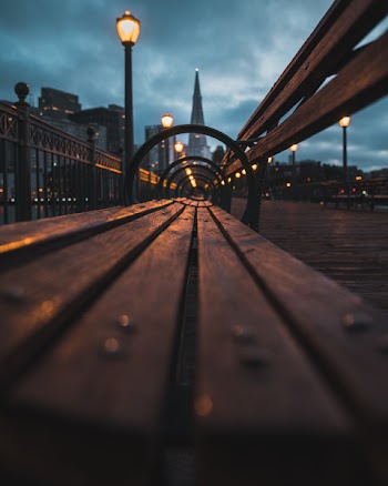 Closeup Photo of Wooden Bench Near the Lamp Post during Night Time