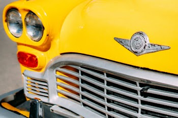 Closeup Photograph of Yellow Car Grille