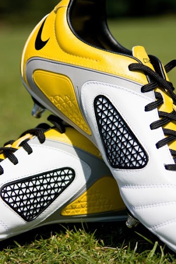 Closeup Photography of White-and-yellow Nike Low-top Cleats