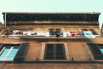 clothes hanging near window on 2nd floor