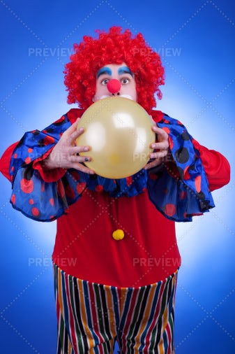 Clown Blowing A Balloon