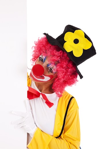 clown holding and looking to a blank banner (isolated on white)