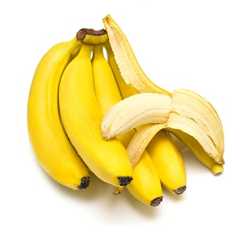Cluster of ripe bananas. One banana is cleared away from a peel. Isolation, shallow DOF.