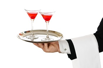 Cocktail waiter carrying two cherry cocktails in glasses on silver tray