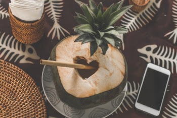 Coconut Juice With Straw Near Smartphone