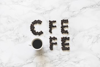 Coffee Beans and White Ceramic Mug With Black Liquid