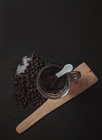 Coffee on Clear Glass Mug Beside Coffee Beans