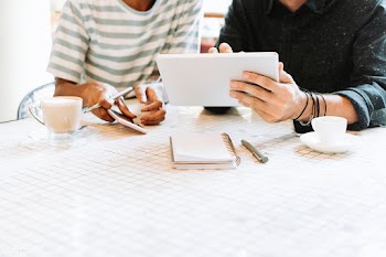 Colleagues discussing their work on a tablet
