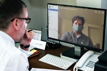 Colleagues having a video conference on a laptop mockup during the cor.. | Free  psd mockup - 2312913