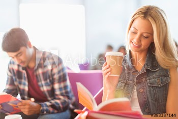 College students with coffee studying in student lounge