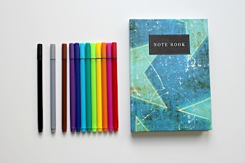 Color Pends Beside Note Book